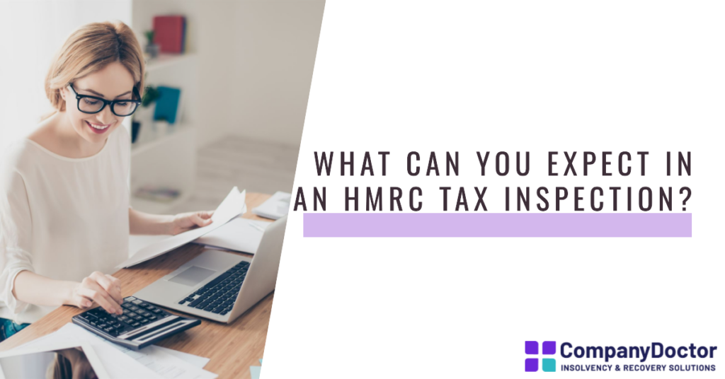 A woman sat at a desk maing sure accounts are correct before HMRC Tax Inspection